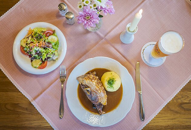 Gaststube, gedeckter Tisch von oben fotografiert mit Schäufele, Kloß, Salat und Weizen