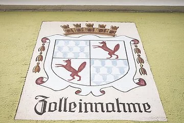 Historische Wandmalerei an der Außenwand des Zollhauses mit Stadtwappen und den Worten "Zolleinnahme".