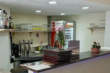 Eine hohe Theke mit roter Beschriftung "San Cono"