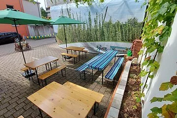 Ein kleiner Biergarten mit Bierbänken