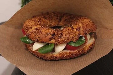 Sesamkringel mit Tomate Mozarella und Basilikum belegt